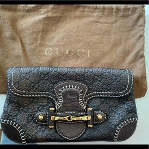 Gucci (authentic) embossed leather clutch bag.